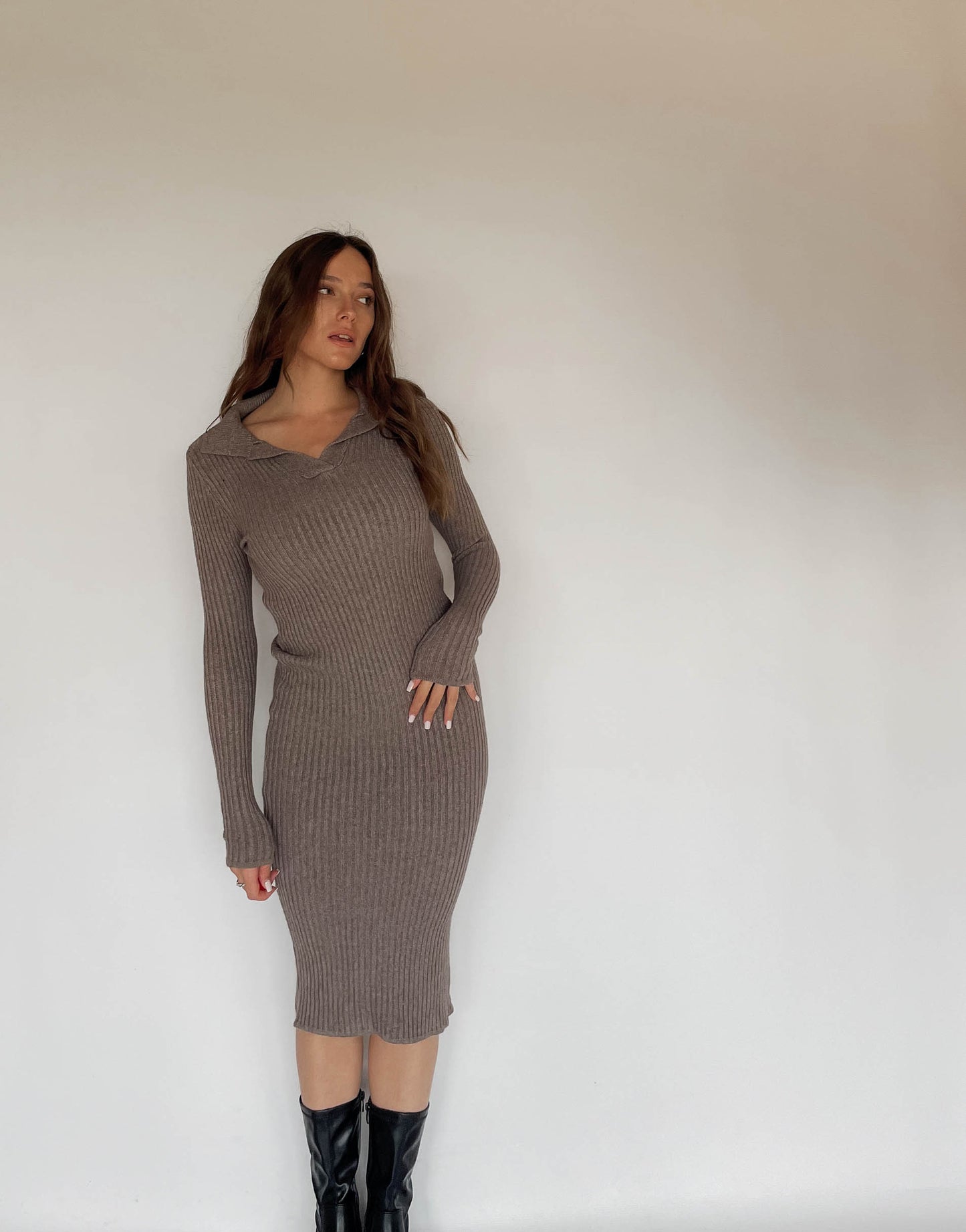 Frau mit brauen Haaren trägt Strickkleid in Taupe