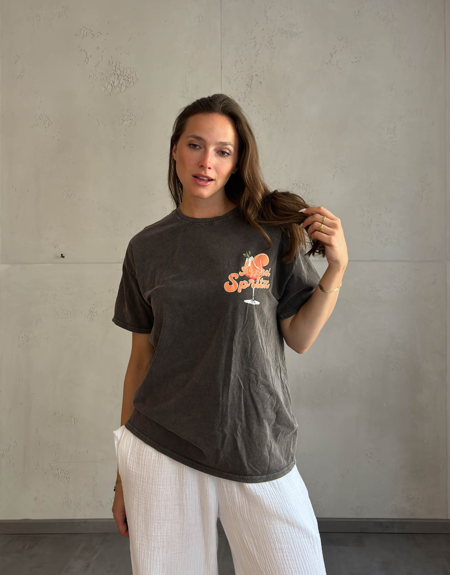 Frau mit braunen Haaren trägt Aperol Spritz T-Shirt 