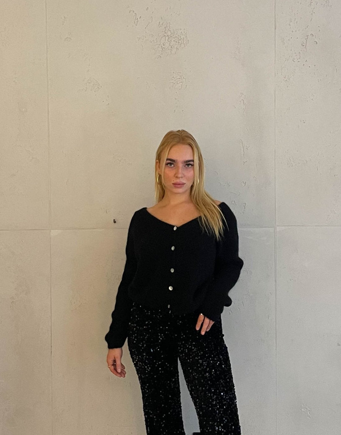 Frau mit brauen Haaren trägt kurze Mohair Strickjacke in schwarz